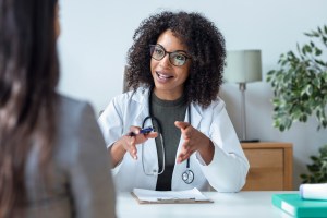 Primary care doctor in consultation with patient in modern medical office