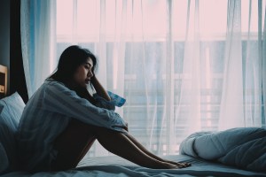 Woman on bed sad, grieving