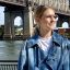 Ashley Oerman, health writer and editor, standing in front of the Brooklyn Bridge in NYC.