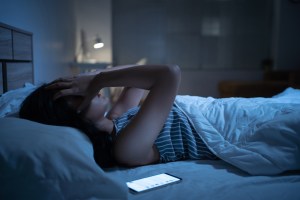 Woman laying in bed not able to sleep