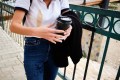 Close up of woman's torso who spilled coffee on her white shirt and jeans